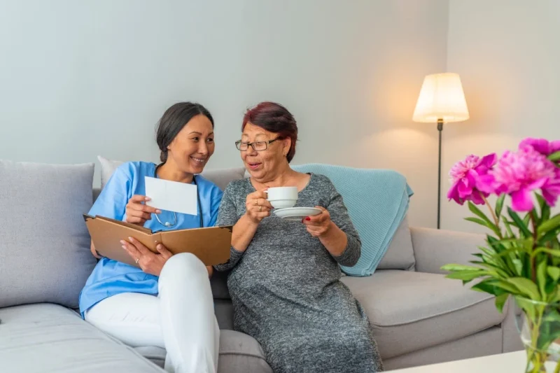Nurse sitting on couch with patient